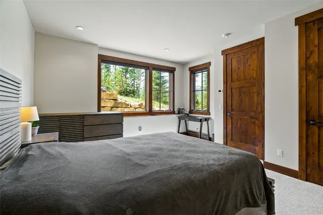 a spacious bedroom with a bed and a large window