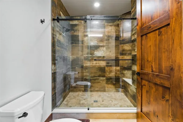 a bathroom with a shower and toilet