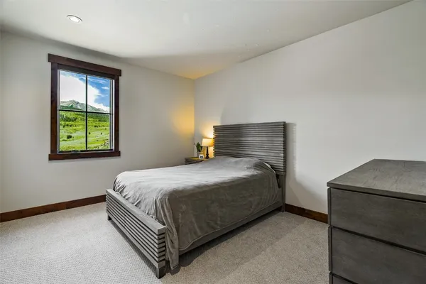 a bed sitting in a bedroom next to a window