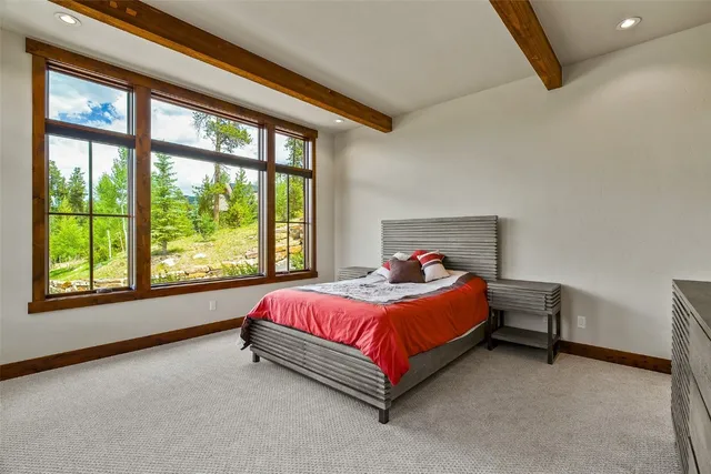 a bed sitting in a bedroom next to a window