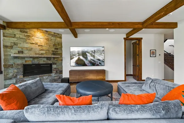 a living room with furniture a rug and a fireplace