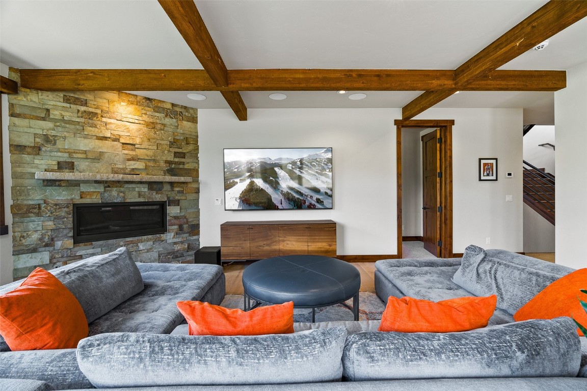 455 Highfield Trail Breckenridge, CO 80424 - Photo 33 of 50 a living room with furniture a rug and a fireplace