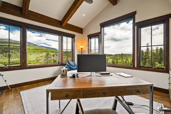 a view of a dining room with a table and chairs