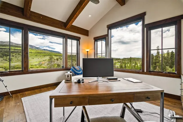 a view of a dining room with a table and chairs