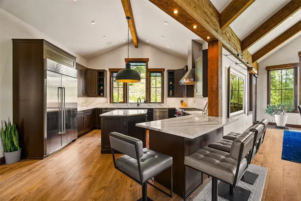 a view of a dining room with furniture and a large window