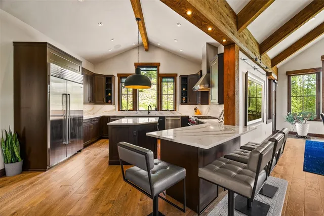 a view of a dining room with furniture and a large window