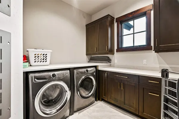 a utility room with sink dryer and washer