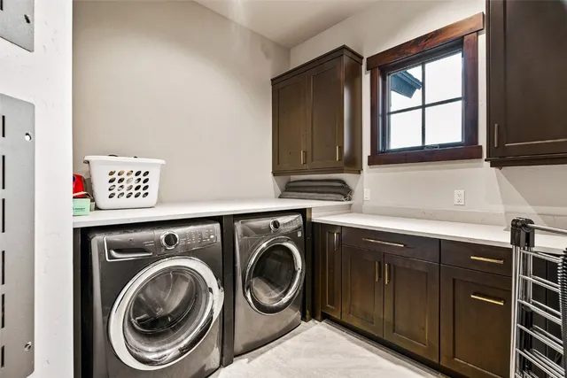 a utility room with sink dryer and washer