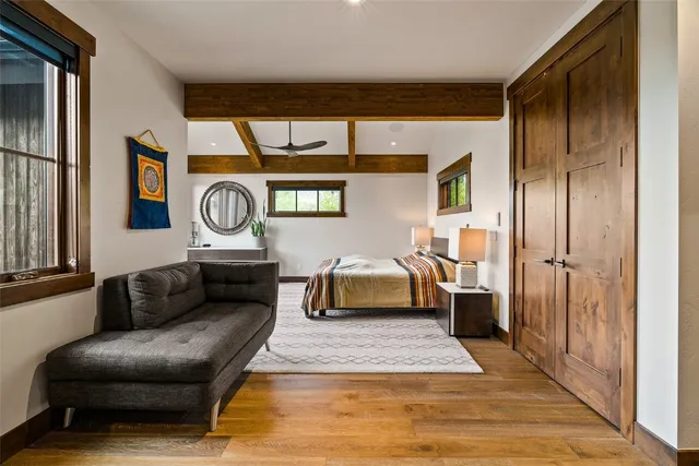 a living room with a couch and a clock