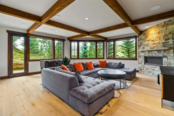 a living room with furniture large window and a fireplace