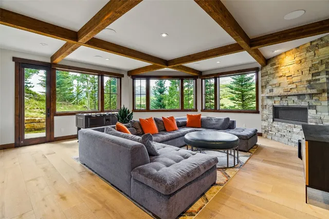 a living room with furniture large window and a fireplace