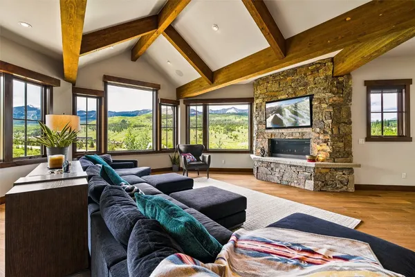 a living room with furniture and a floor to ceiling window