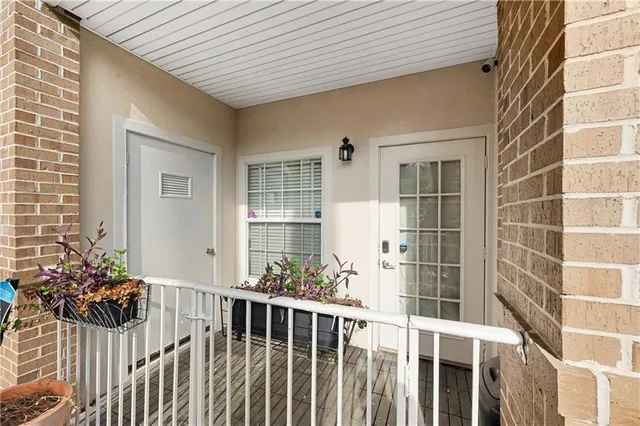 a view of a porch with wooden chairs