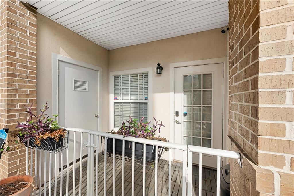 220 Renaissance Parkway Northeast, Unit 2119 Atlanta, GA 30308 - Photo 1 of 19 a view of a porch with wooden chairs