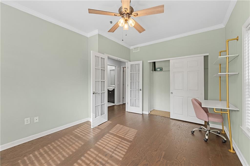 220 Renaissance Parkway Northeast, Unit 2119 Atlanta, GA 30308 - Photo 11 of 19 a view of a workspace with furniture and a chandelier fan
