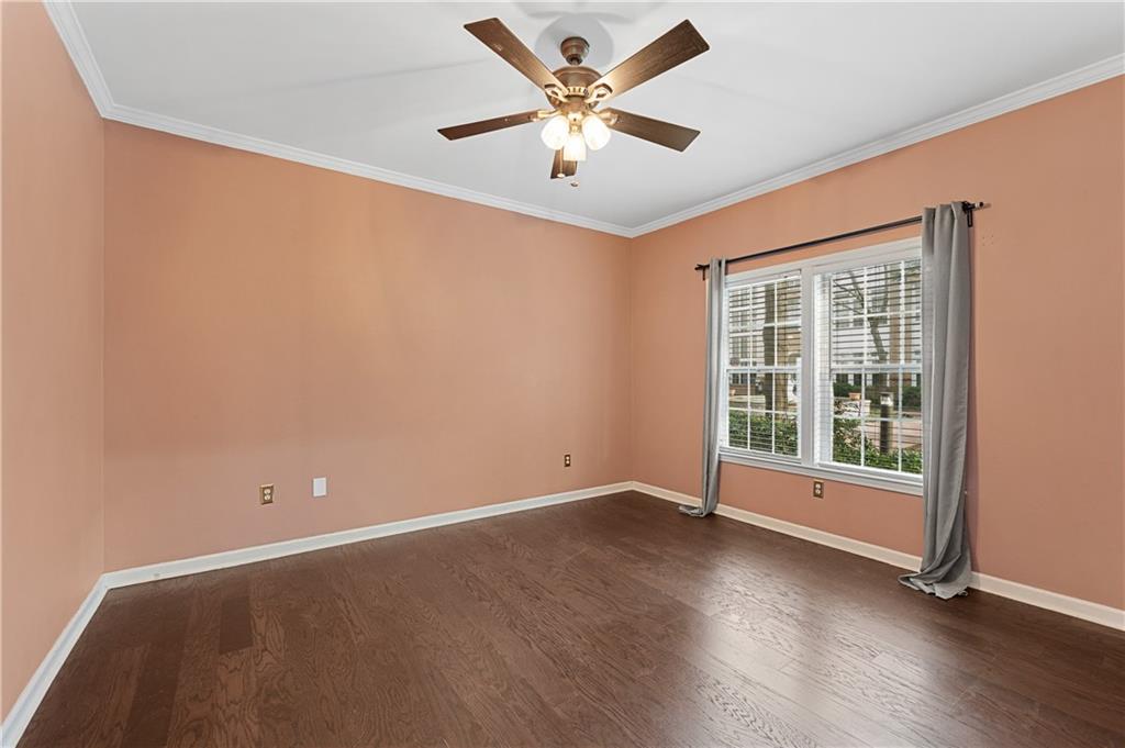 220 Renaissance Parkway Northeast, Unit 2119 Atlanta, GA 30308 - Photo 15 of 19 an empty room with wooden floor and windows
