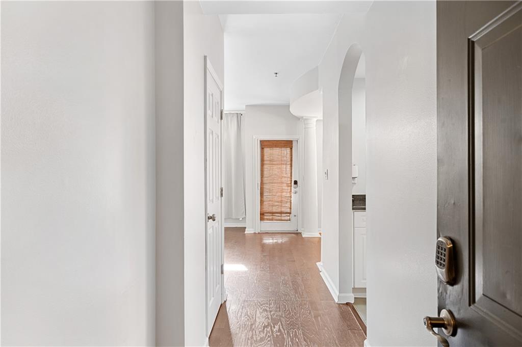 220 Renaissance Parkway Northeast, Unit 2119 Atlanta, GA 30308 - Photo 2 of 19 a view of a hallway with wooden floor