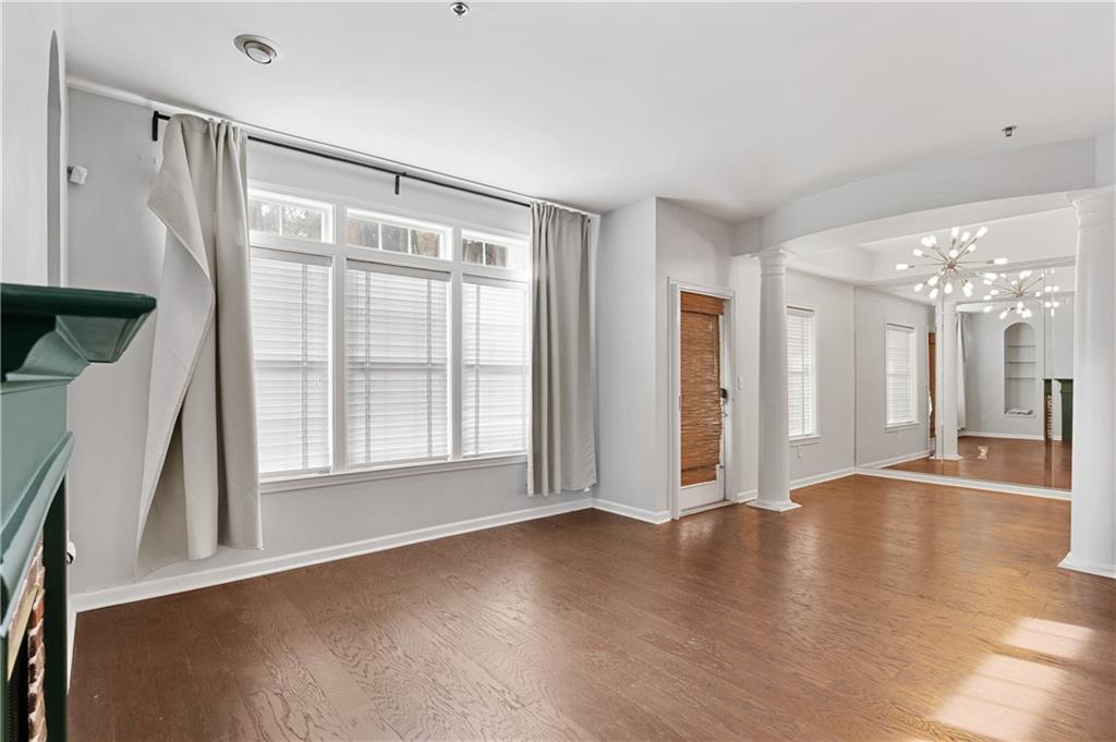 220 Renaissance Parkway Northeast, Unit 2119 Atlanta, GA 30308 - Photo 6 of 19 a view of an empty room with wooden floor and a window