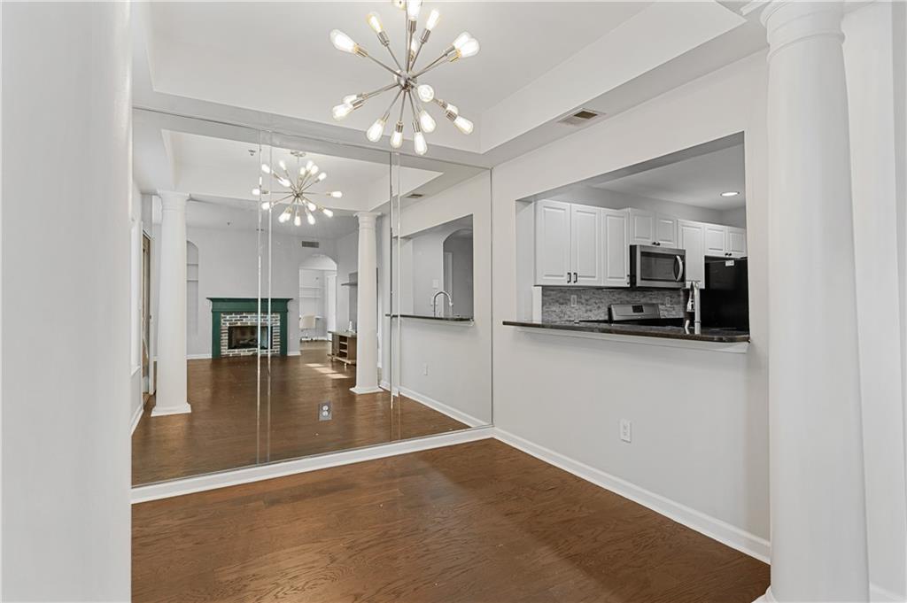 220 Renaissance Parkway Northeast, Unit 2119 Atlanta, GA 30308 - Photo 9 of 19 a view of a kitchen with a refrigerator a microwave and dining table