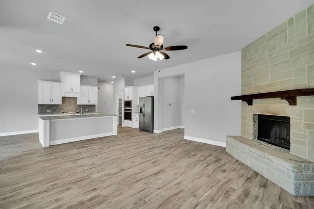 a view of kitchen with granite countertop cabinets and wooden floor