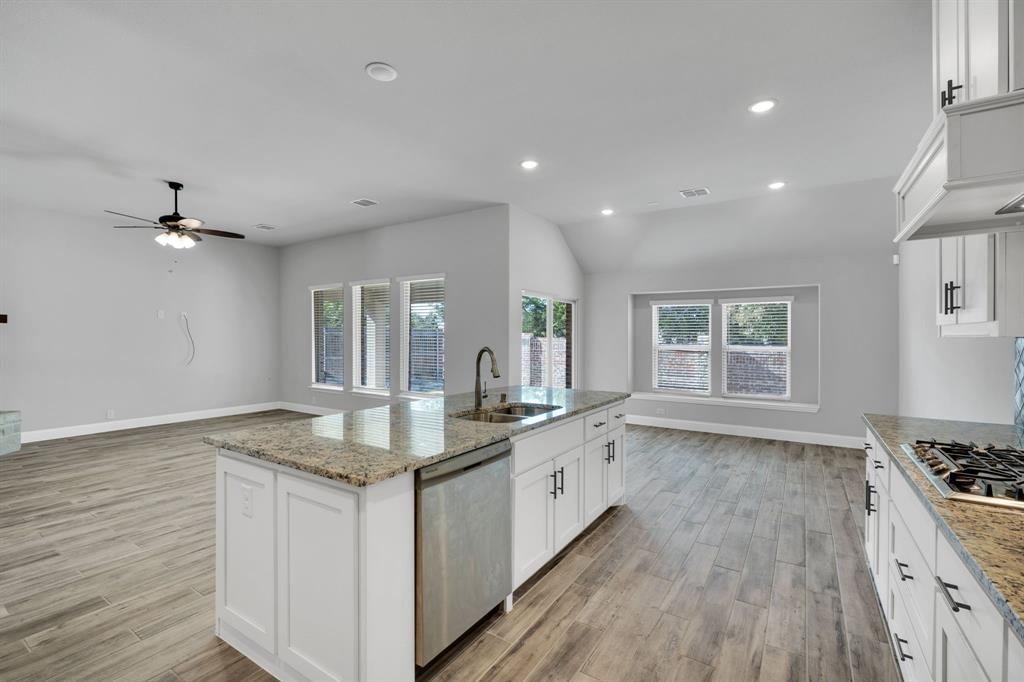 1913 Winter Lane Midlothian, TX 76065 - Photo 8 of 34 a kitchen with granite countertop a sink stove and cabinets