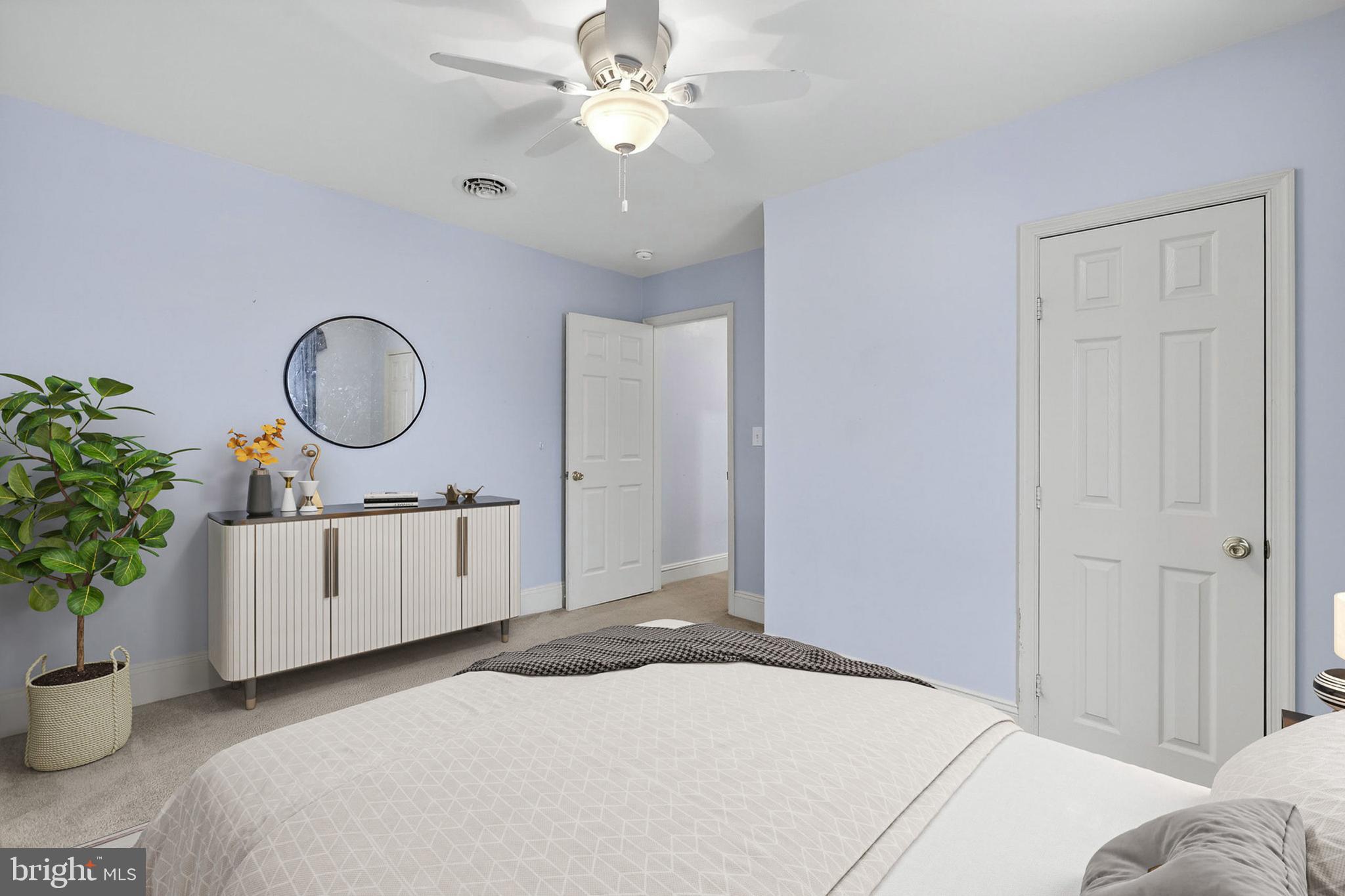 110 West Camden Wyoming Avenue Wyoming, DE 19934 - Photo 11 of 32 a bedroom with a bed a chandelier and a mirror