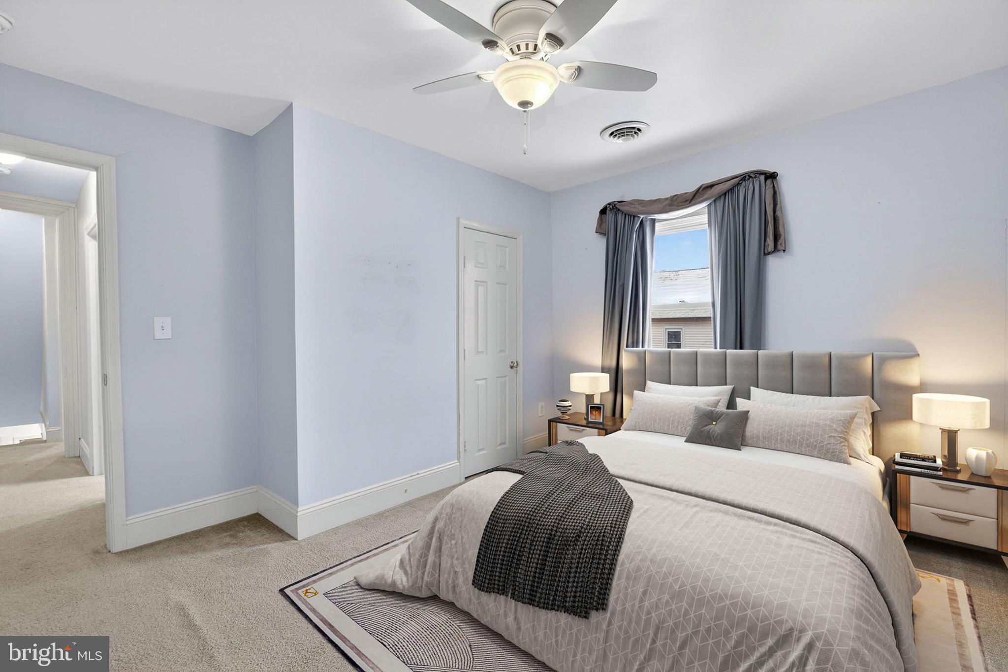 110 West Camden Wyoming Avenue Wyoming, DE 19934 - Photo 12 of 32 a bedroom with a bed and a chandelier