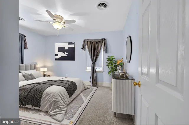 a bedroom with bed and a chandelier