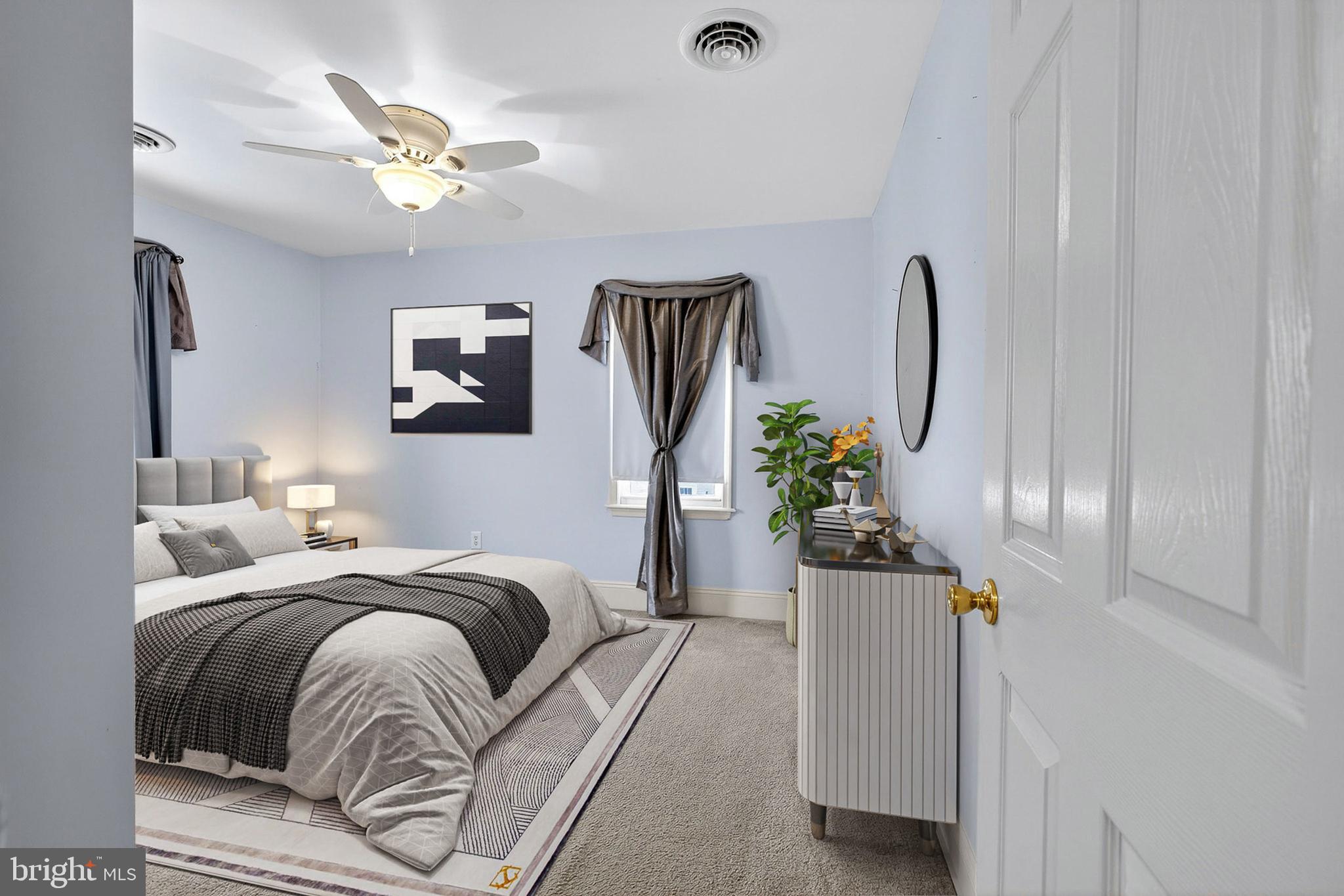 110 West Camden Wyoming Avenue Wyoming, DE 19934 - Photo 13 of 32 a bedroom with bed and a chandelier