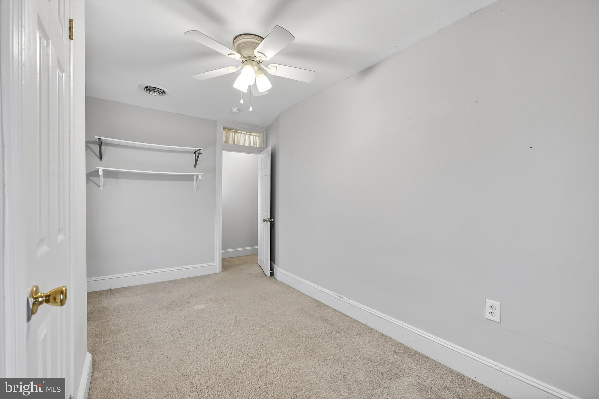 110 West Camden Wyoming Avenue Wyoming, DE 19934 - Photo 17 of 32 an empty room with a chandelier fan and closet