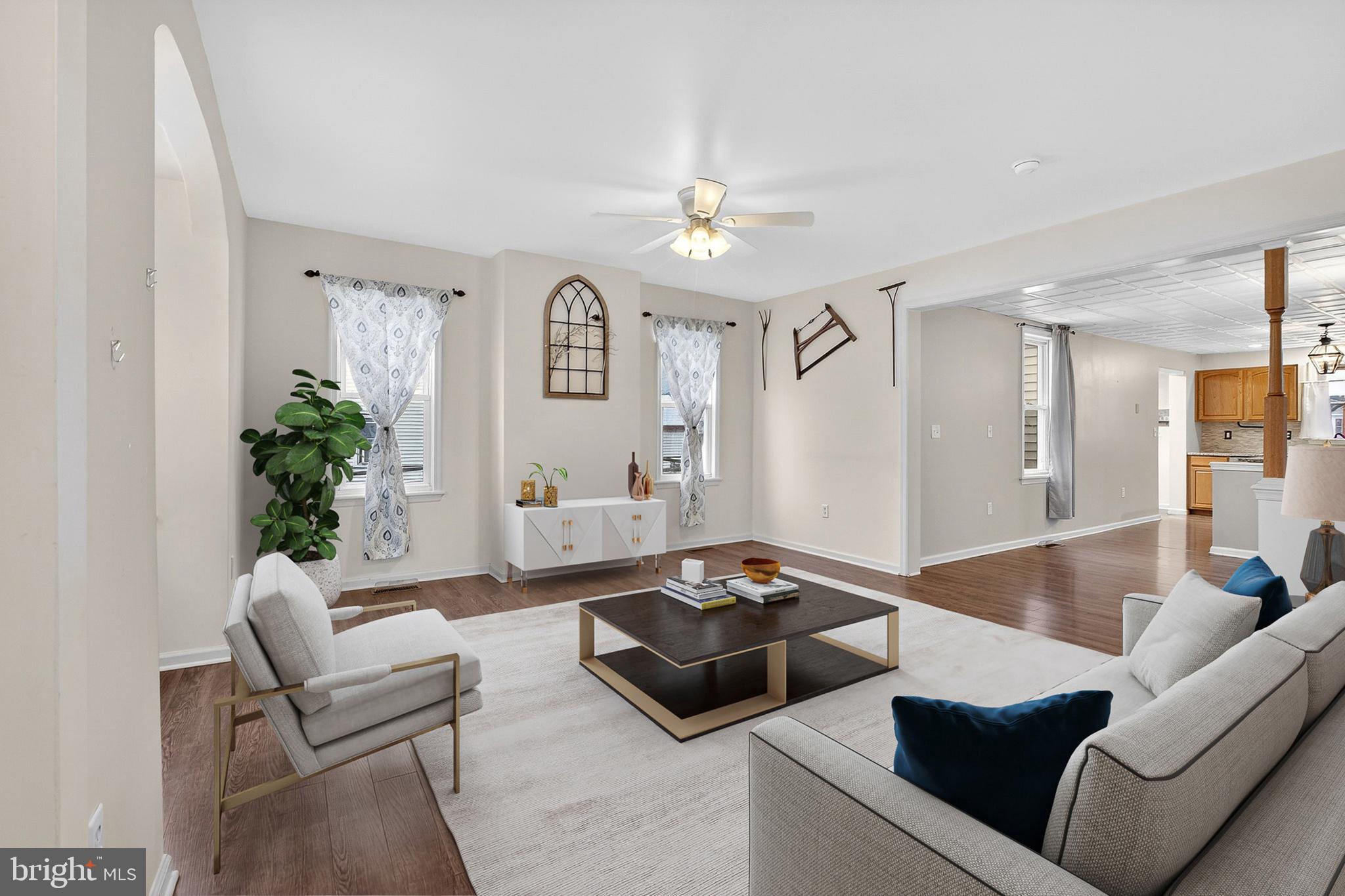 110 West Camden Wyoming Avenue Wyoming, DE 19934 - Photo 2 of 32 a living room with furniture and a chandelier