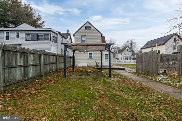 a view of a house with a large window and wooden fence
