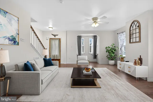 a living room with furniture and a chandelier