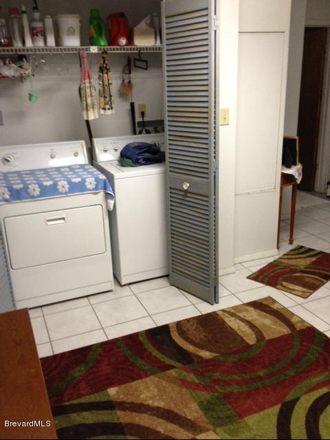 922 Clearlake Road Cocoa, FL 32922 - Photo 12 of 31 a bedroom with a bed and a flat screen tv