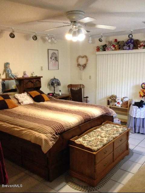 922 Clearlake Road Cocoa, FL 32922 - Photo 15 of 31 a bedroom with bed and a lamp with window