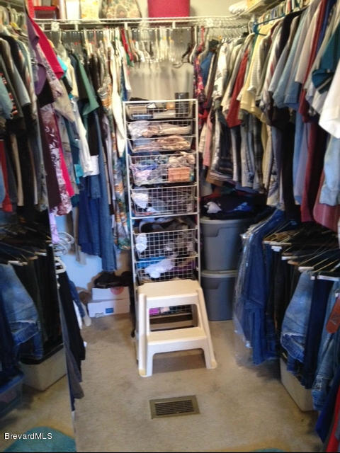 922 Clearlake Road Cocoa, FL 32922 - Photo 21 of 31 a view of walk in closet with clothes and shoes