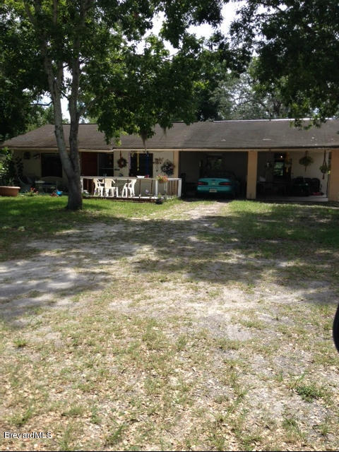 922 Clearlake Road Cocoa, FL 32922 - Photo 5 of 31 a front view of a house with a garden