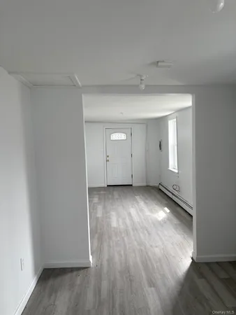 a view of an empty room and wooden floor