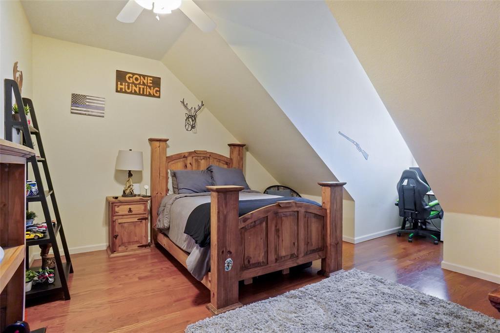 13340 John Day Road Haslet, TX 76052 - Photo 20 of 30 a bedroom with furniture and a book shelf