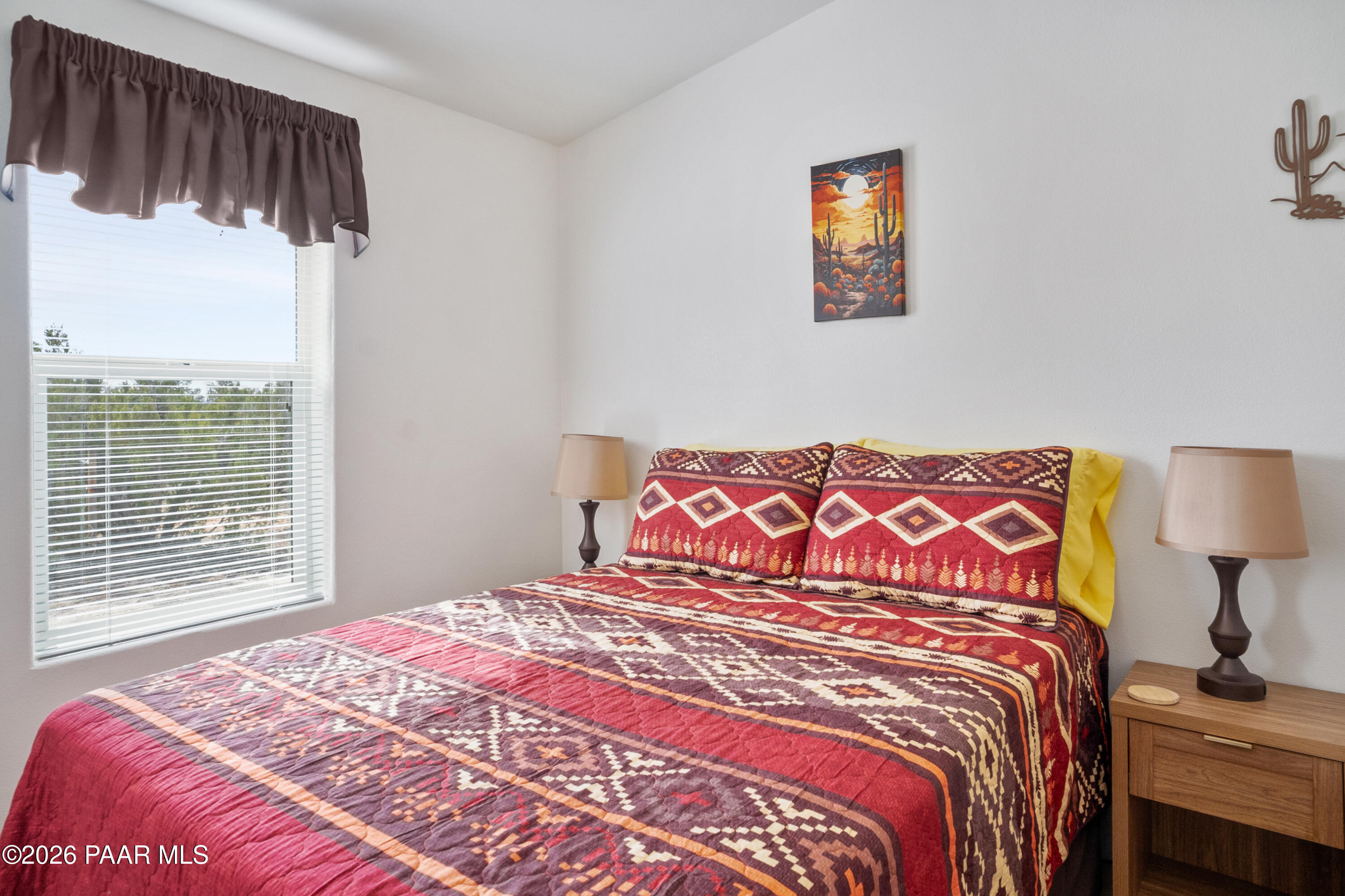 25815 Fort Rock Road Seligman, AZ 86337 - Photo 11 of 30 a bedroom with a bed and window