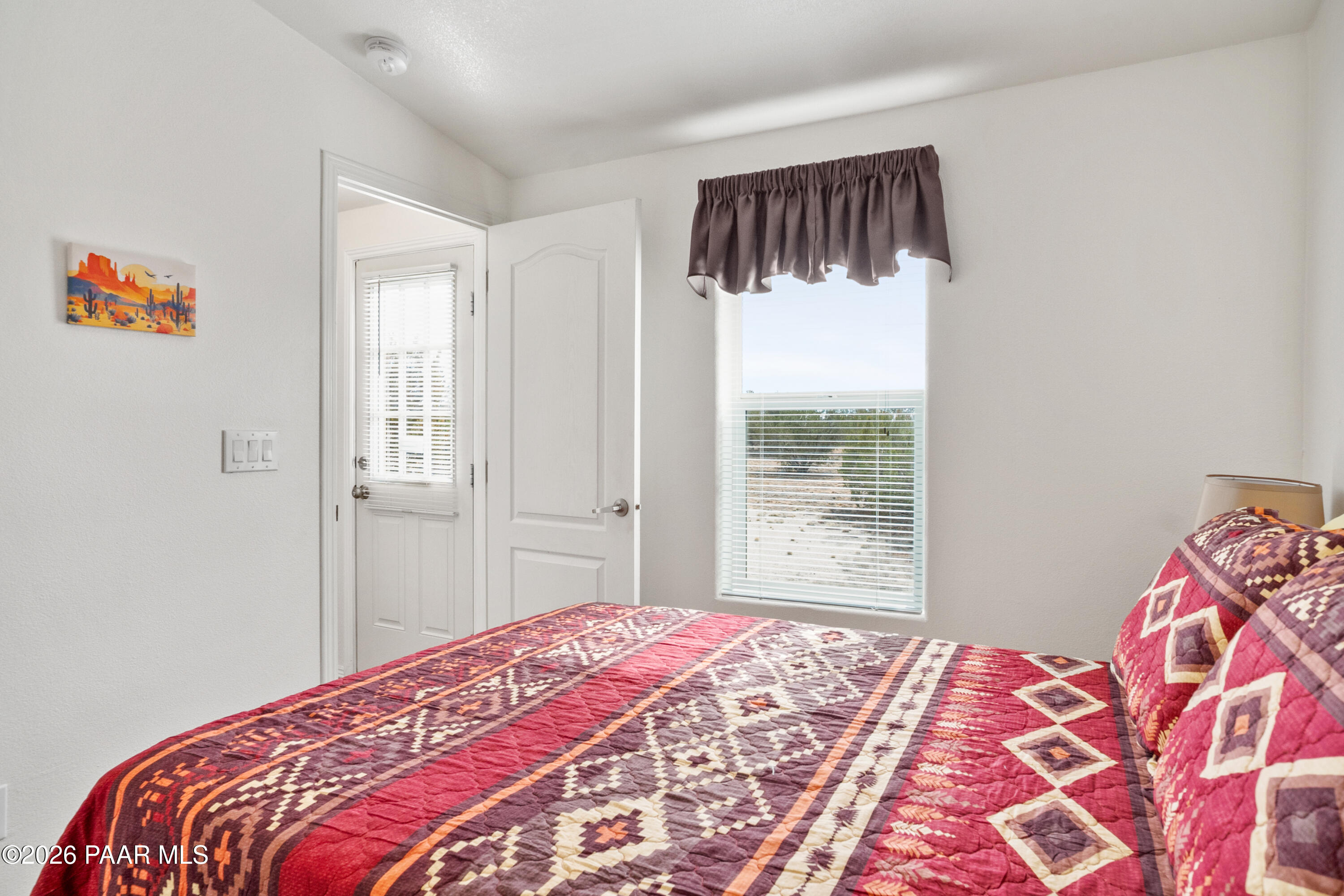 25815 Fort Rock Road Seligman, AZ 86337 - Photo 12 of 30 a bedroom with a bed and a window
