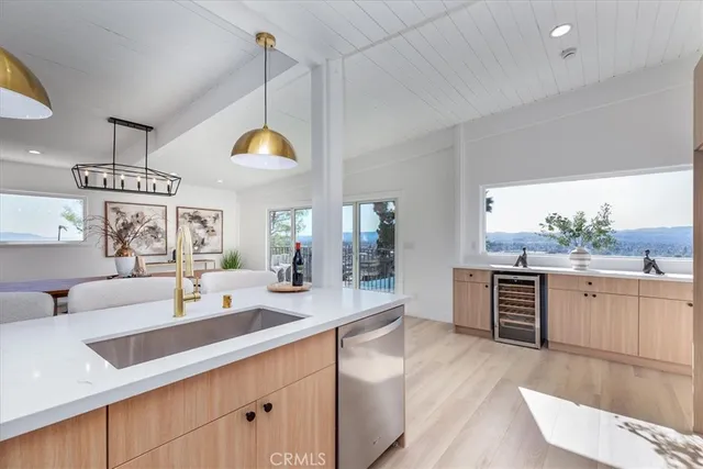 a kitchen with a refrigerator a stove and white cabinets