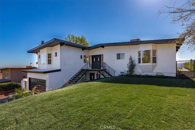 a front view of house with yard and outdoor seating