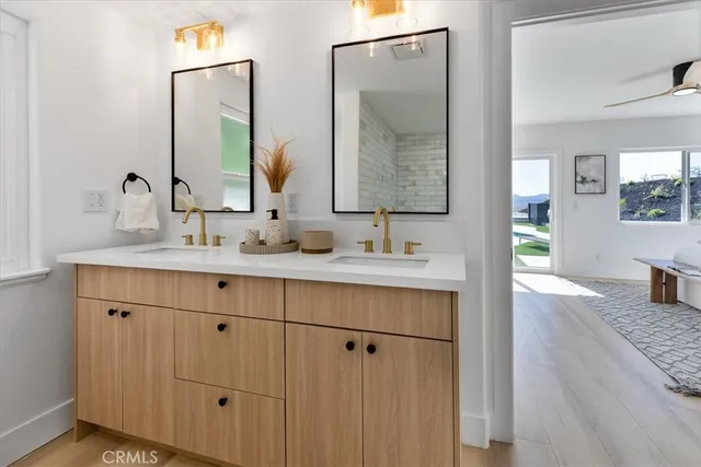 a bathroom with a sink vanity and mirror