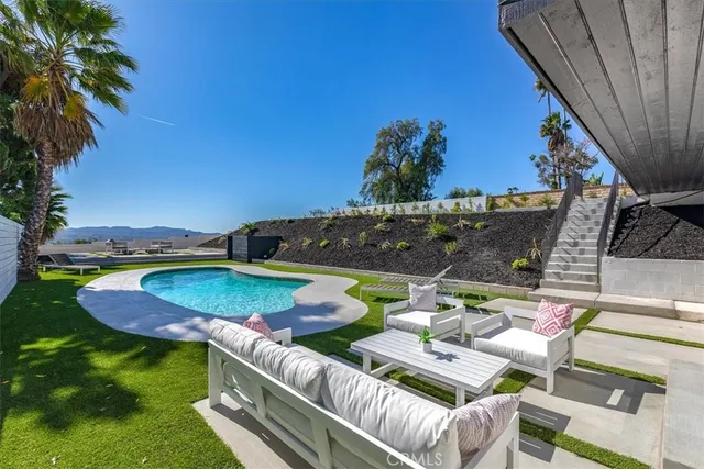 a view of an outdoor sitting area with furniture