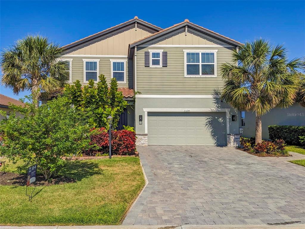 3324 Big Sky Way Lakewood Ranch, FL 34211 - Photo 1 of 49 a front view of house with yard and trees around