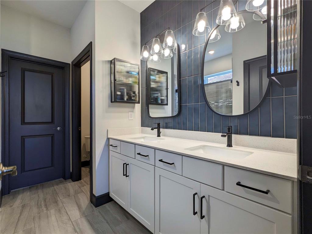 3324 Big Sky Way Lakewood Ranch, FL 34211 - Photo 12 of 49 a bathroom with a double vanity sink and a mirror