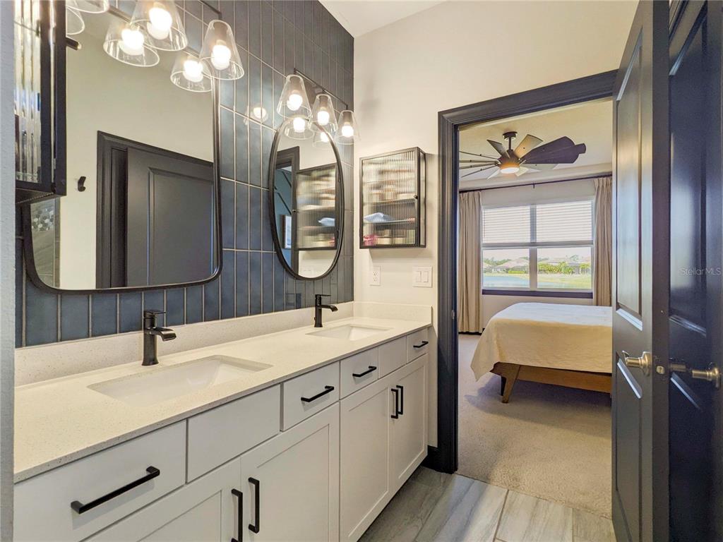 3324 Big Sky Way Lakewood Ranch, FL 34211 - Photo 14 of 49 a en suite bathroom with a double vanity sink and a mirror
