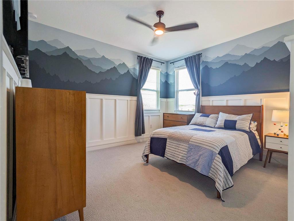 3324 Big Sky Way Lakewood Ranch, FL 34211 - Photo 20 of 49 a spacious bedroom with a bed and a chandelier