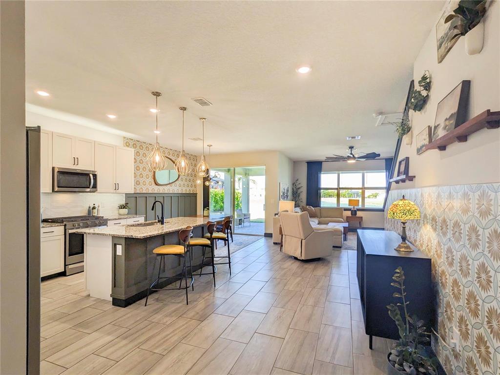 3324 Big Sky Way Lakewood Ranch, FL 34211 - Photo 4 of 49 a living room with furniture kitchen view and a wooden floor